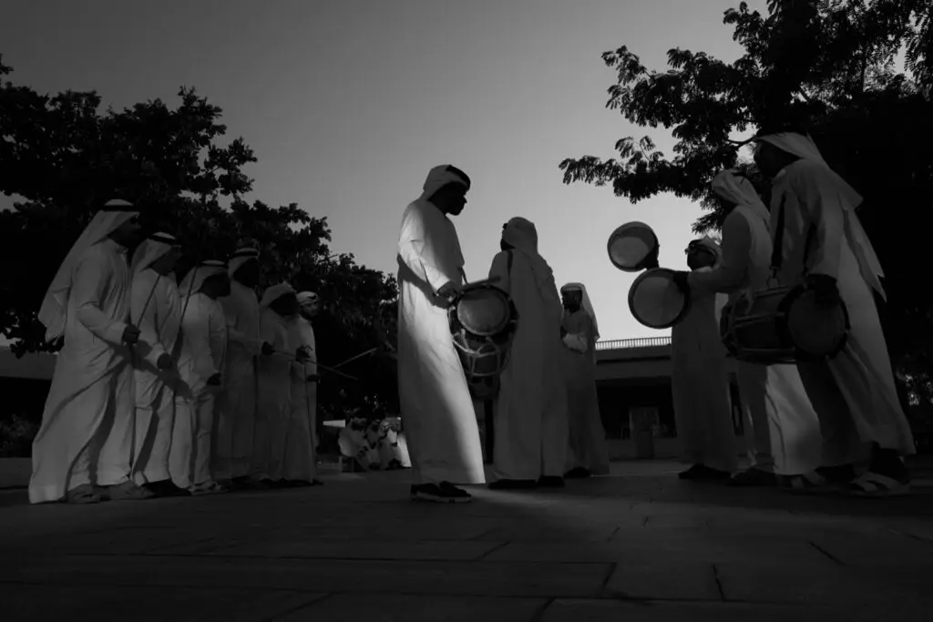 A circle of drummers at dusk